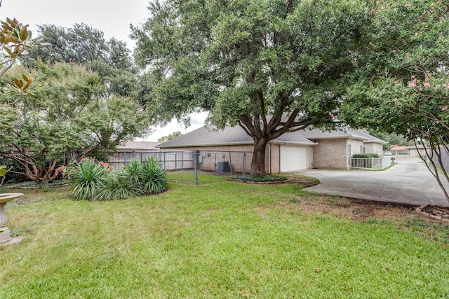 view of yard featuring central AC and a garage