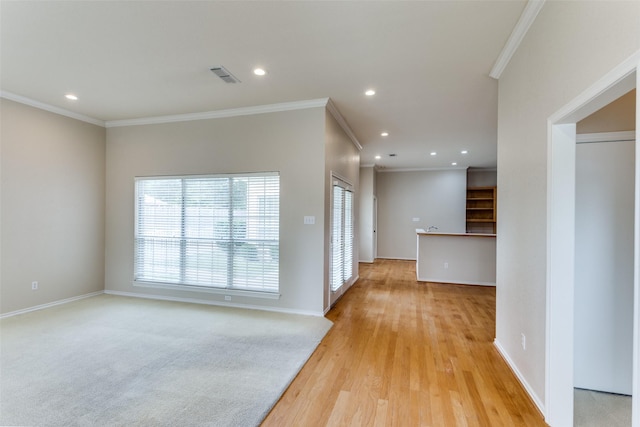 unfurnished room with crown molding and light wood-type flooring