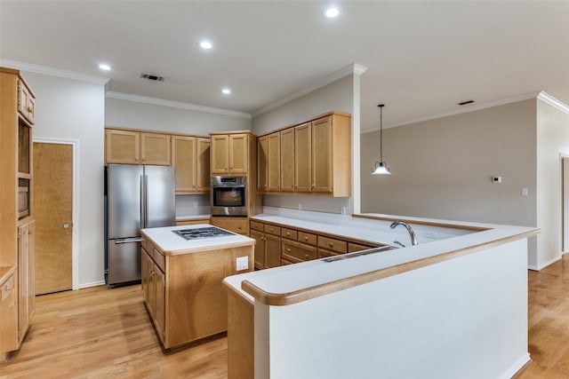 kitchen with sink, hanging light fixtures, stainless steel appliances, a kitchen island, and kitchen peninsula