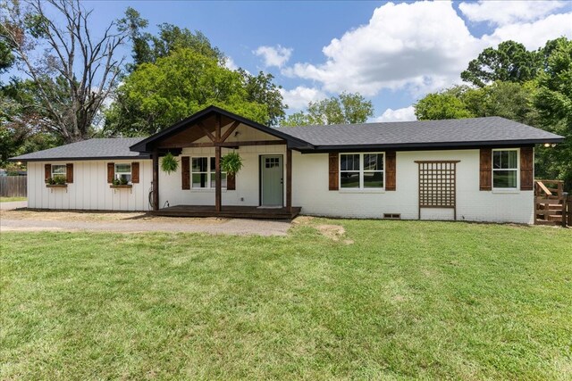 ranch-style home with a front lawn