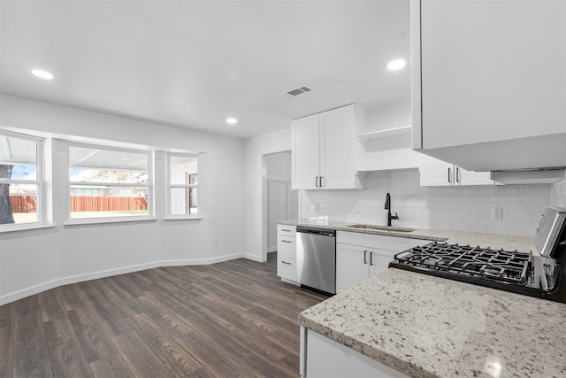 kitchen featuring stainless steel dishwasher, dark hardwood / wood-style flooring, white cabinets, sink, and stove