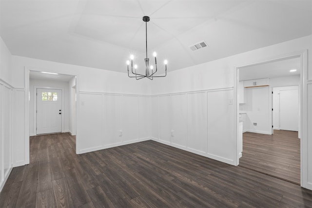 interior space with a notable chandelier and dark hardwood / wood-style flooring