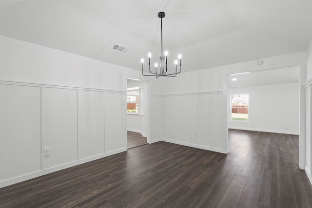 unfurnished dining area featuring a notable chandelier and hardwood / wood-style floors