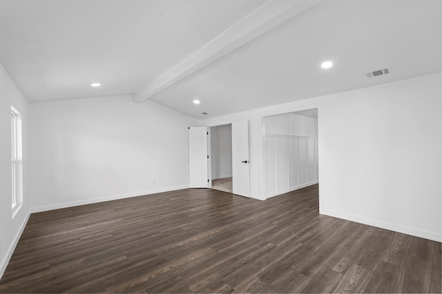 unfurnished room with wood-type flooring and vaulted ceiling with beams