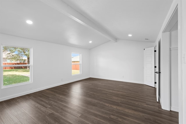 unfurnished room featuring plenty of natural light, lofted ceiling with beams, and hardwood / wood-style floors