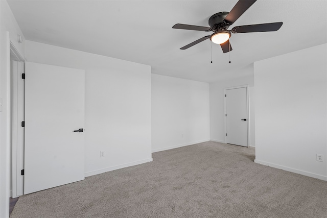 unfurnished room with light colored carpet and ceiling fan