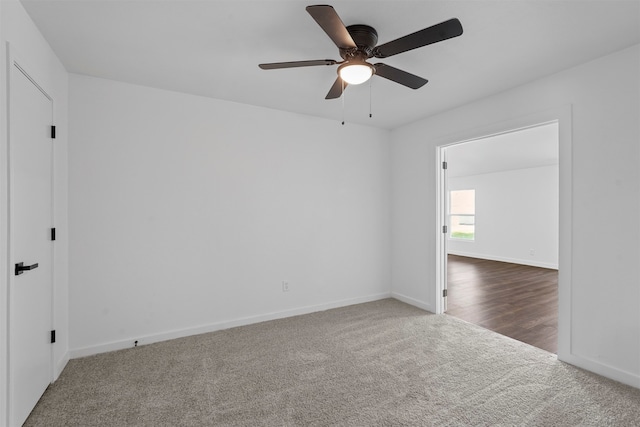 carpeted spare room with ceiling fan