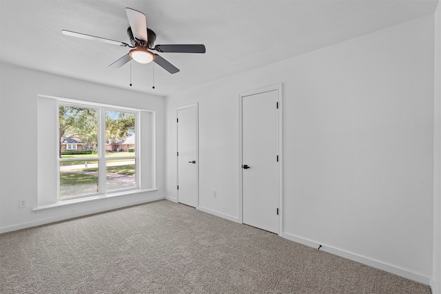 unfurnished bedroom with carpet floors and ceiling fan