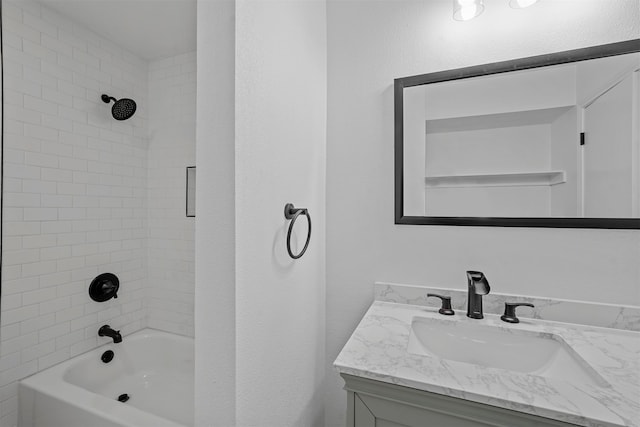 bathroom with tiled shower / bath combo and vanity