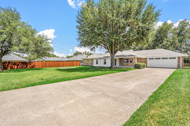 single story home featuring a garage and a front yard