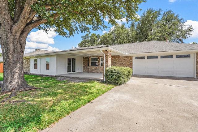 ranch-style house with a garage and a front yard