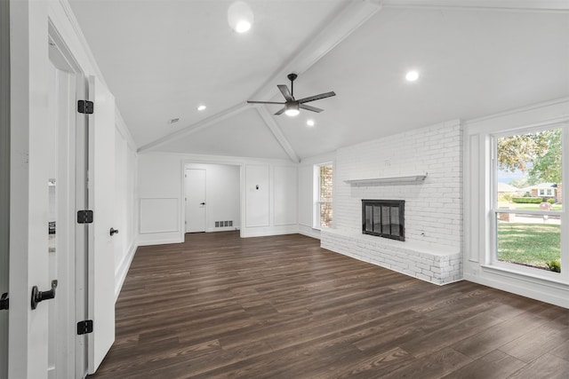 unfurnished living room with lofted ceiling with beams, a fireplace, dark wood-type flooring, and ceiling fan