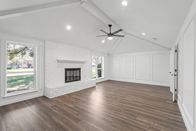 unfurnished living room featuring dark hardwood / wood-style flooring, a brick fireplace, and vaulted ceiling with beams