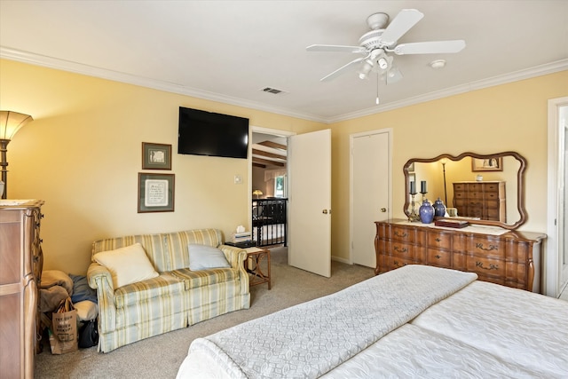 carpeted bedroom featuring ceiling fan and crown molding