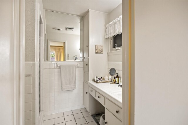 bathroom with vanity, tile patterned floors, and tile walls