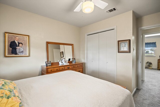 carpeted bedroom with ceiling fan and a closet