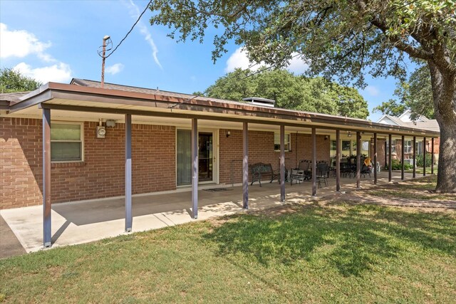 back of house featuring a yard and a patio area