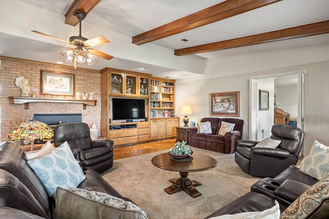 living room featuring a fireplace, built in shelves, beam ceiling, brick wall, and light carpet