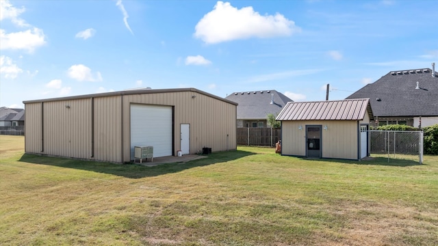 exterior space featuring an outdoor structure, central AC unit, and a yard