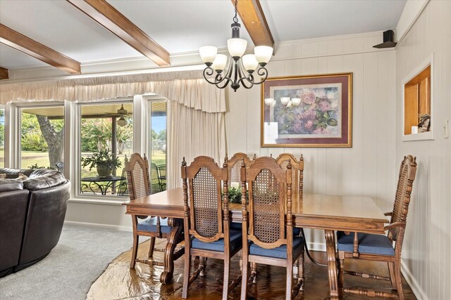 carpeted dining room with a notable chandelier and beam ceiling