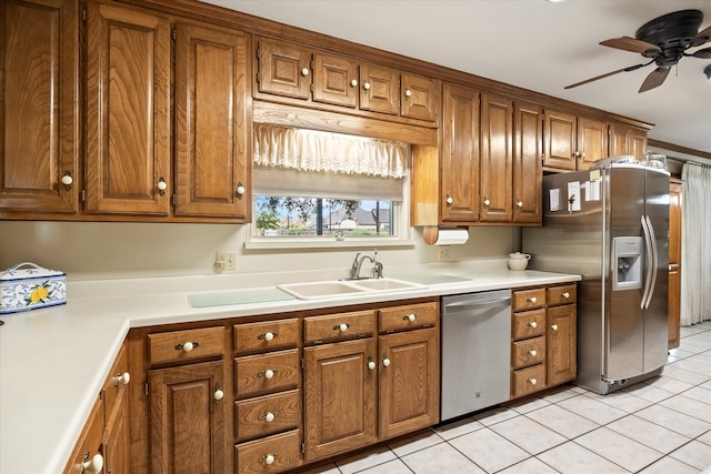 kitchen with sink, ceiling fan, light tile patterned floors, and stainless steel appliances