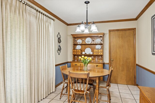 tiled dining area featuring an inviting chandelier and crown molding