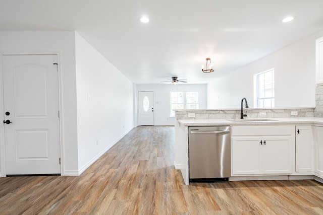 kitchen with sink, light hardwood / wood-style flooring, white cabinets, and dishwasher