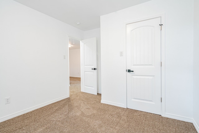 unfurnished bedroom with light carpet