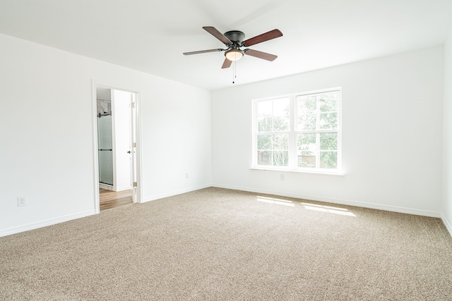 spare room featuring light carpet and ceiling fan