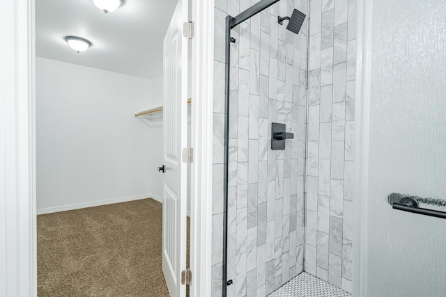 bathroom with a shower with door