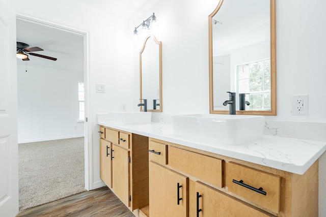 bathroom featuring vanity, hardwood / wood-style flooring, and ceiling fan