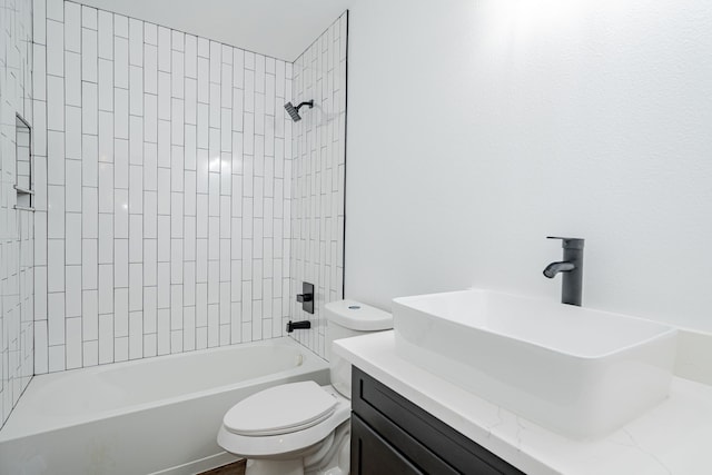 full bathroom featuring tiled shower / bath combo, vanity, and toilet