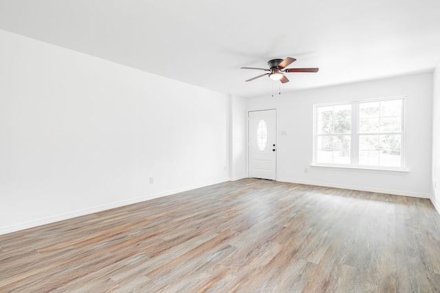 interior space with ceiling fan and light hardwood / wood-style flooring