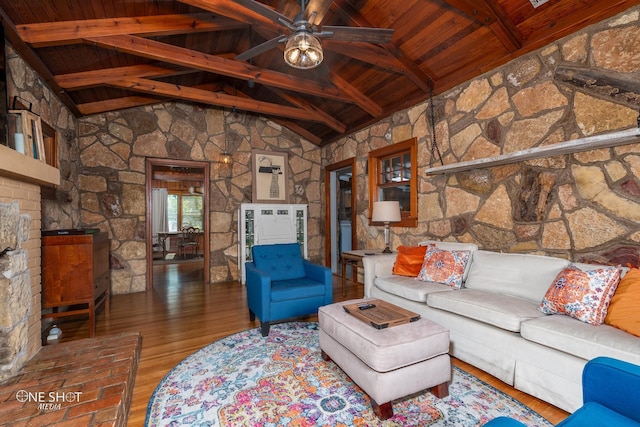 unfurnished living room featuring ceiling fan, hardwood / wood-style flooring, high vaulted ceiling, beamed ceiling, and wood ceiling