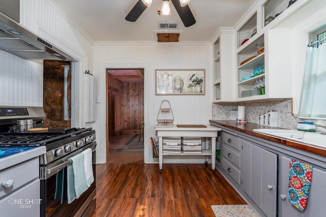 kitchen featuring gray cabinetry, wooden counters, stainless steel gas stove, dark wood-type flooring, and ceiling fan