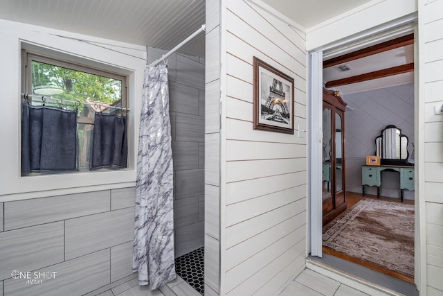 bathroom with beam ceiling, curtained shower, and tile patterned floors