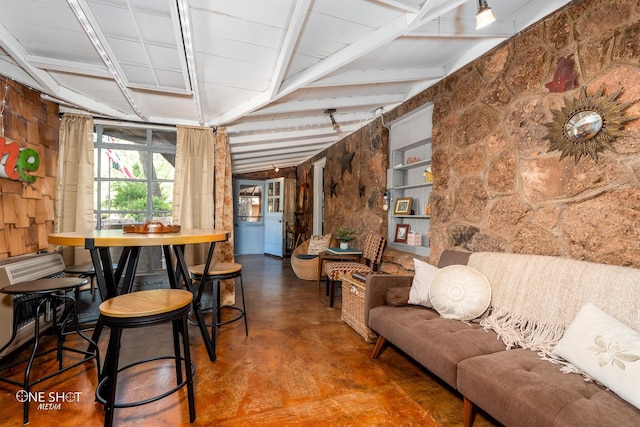 dining room featuring wood walls and vaulted ceiling