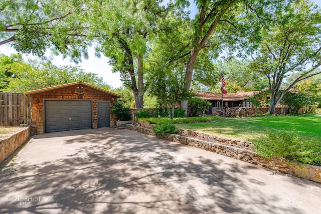 view of front of property with an outbuilding, a garage, and a front lawn