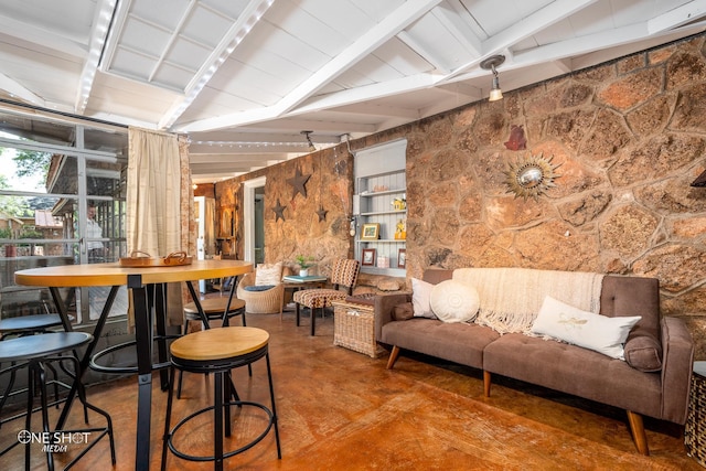 interior space featuring vaulted ceiling with beams