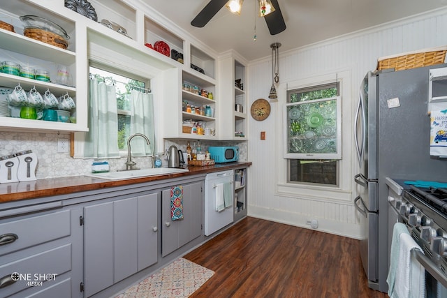 kitchen featuring gray cabinets, wood counters, decorative light fixtures, and stainless steel appliances