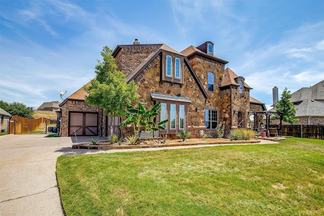 tudor home with a front lawn and a garage