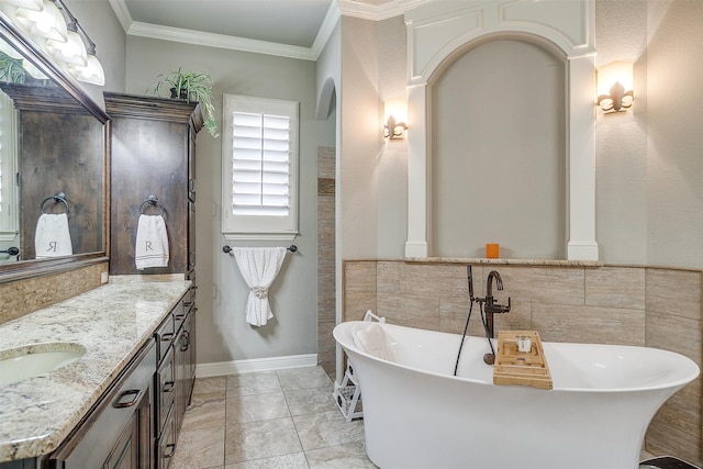 bathroom featuring a tub to relax in, tile patterned flooring, vanity, and ornamental molding