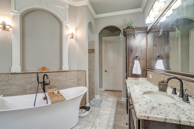 bathroom with tile patterned flooring, vanity, a bath, and ornamental molding