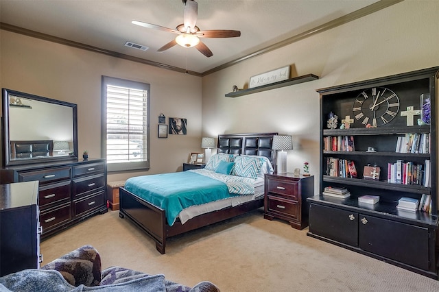 carpeted bedroom featuring ceiling fan and crown molding