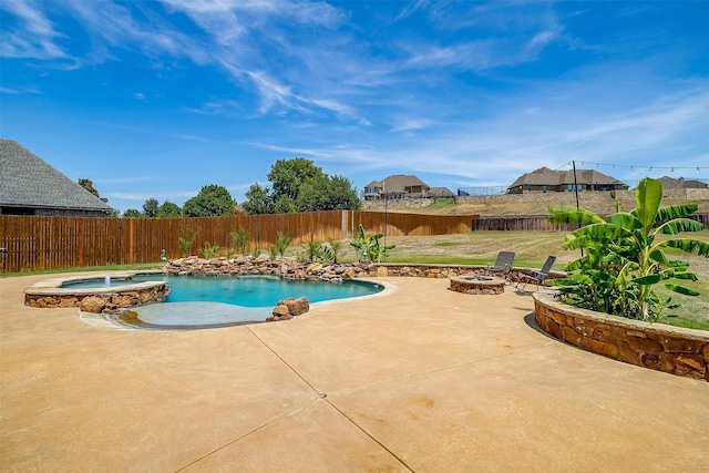 view of pool featuring a fire pit, a patio area, a yard, and an in ground hot tub