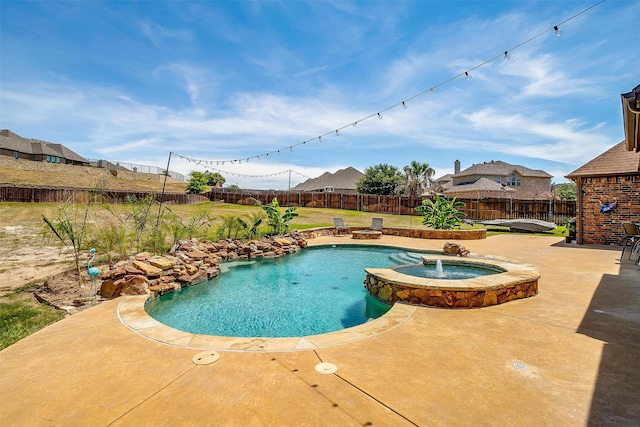 view of swimming pool featuring an in ground hot tub, a yard, and a patio