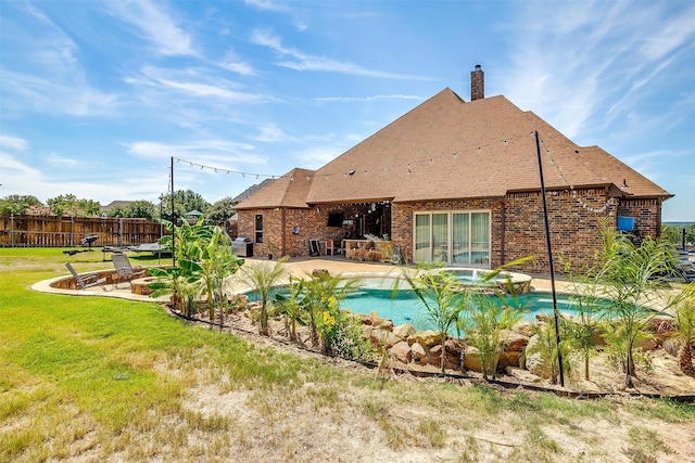 view of swimming pool with a patio area, a yard, and a fire pit