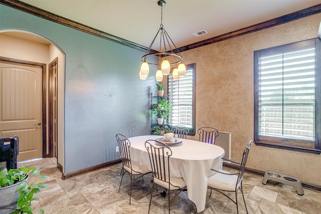 dining room with an inviting chandelier and ornamental molding