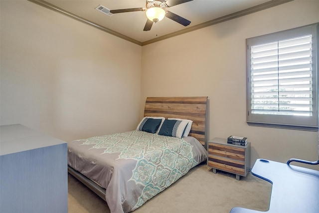 carpeted bedroom with ceiling fan and ornamental molding