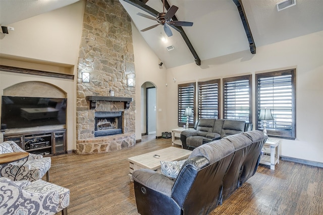 living room with beam ceiling, ceiling fan, high vaulted ceiling, hardwood / wood-style floors, and a fireplace